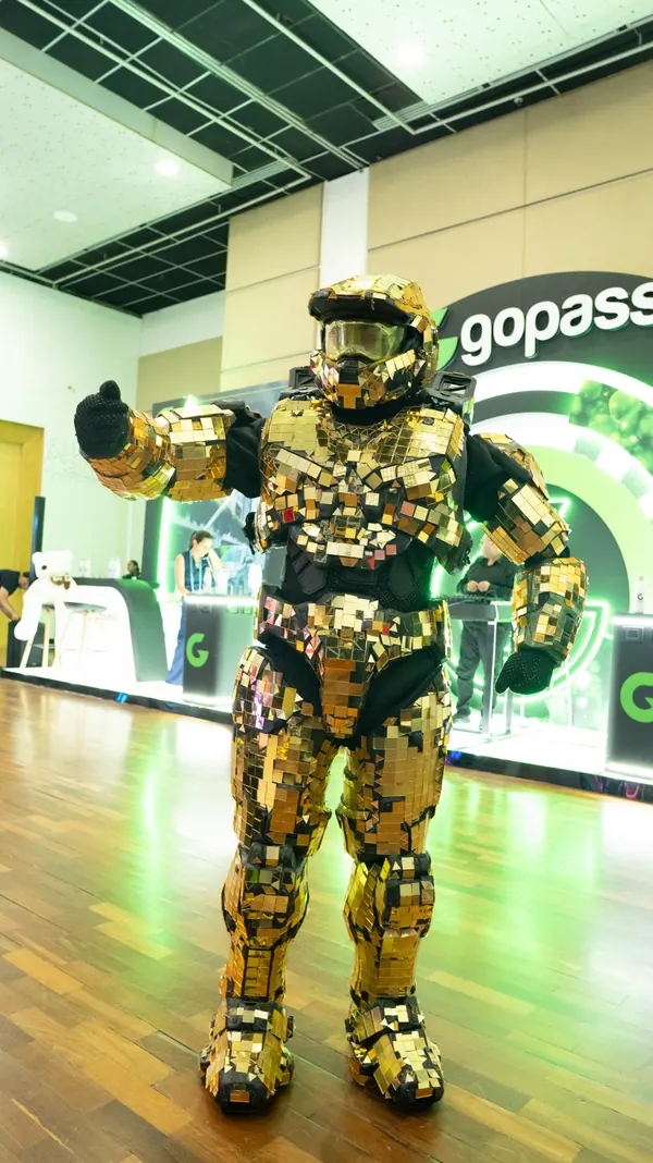 Robot cubierto de espejos dorados saludando